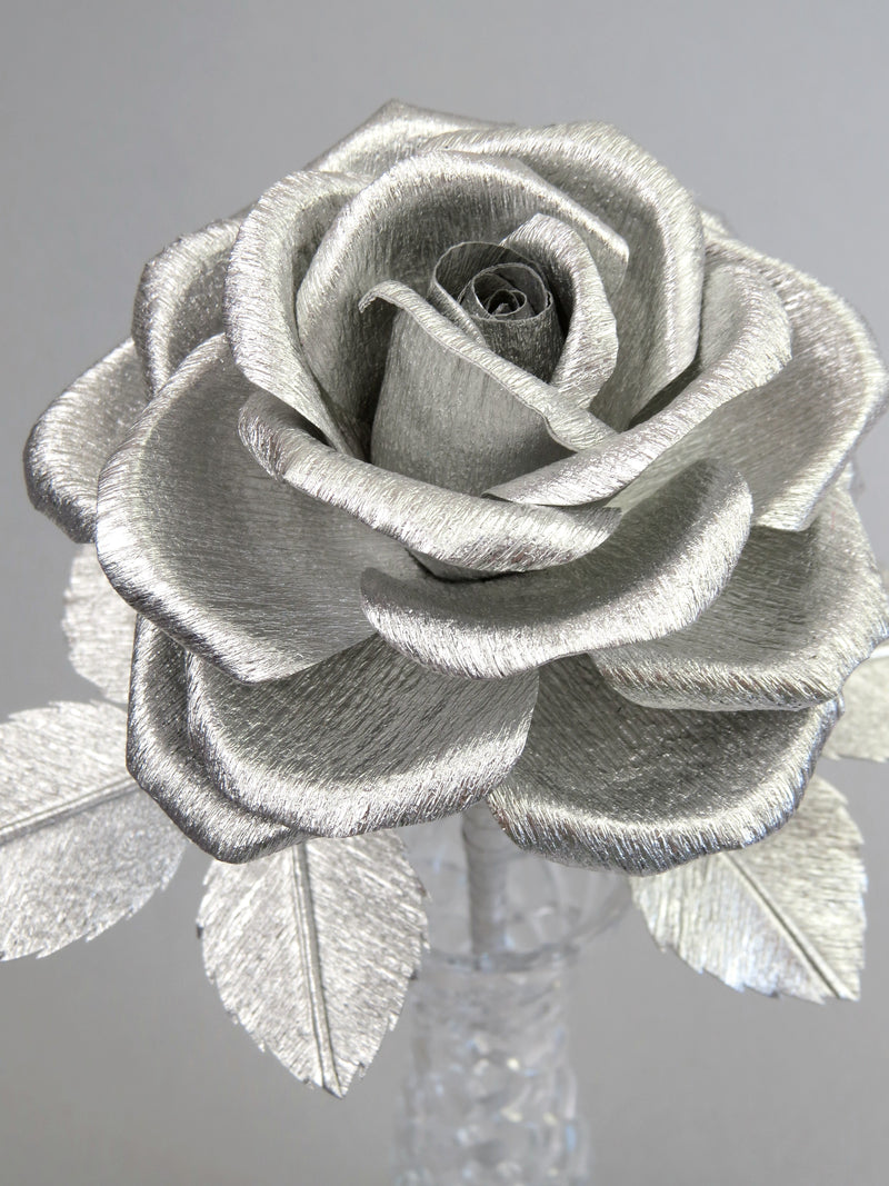 Close up detail of the texture on the petals of a metallic silver crepe paper rose