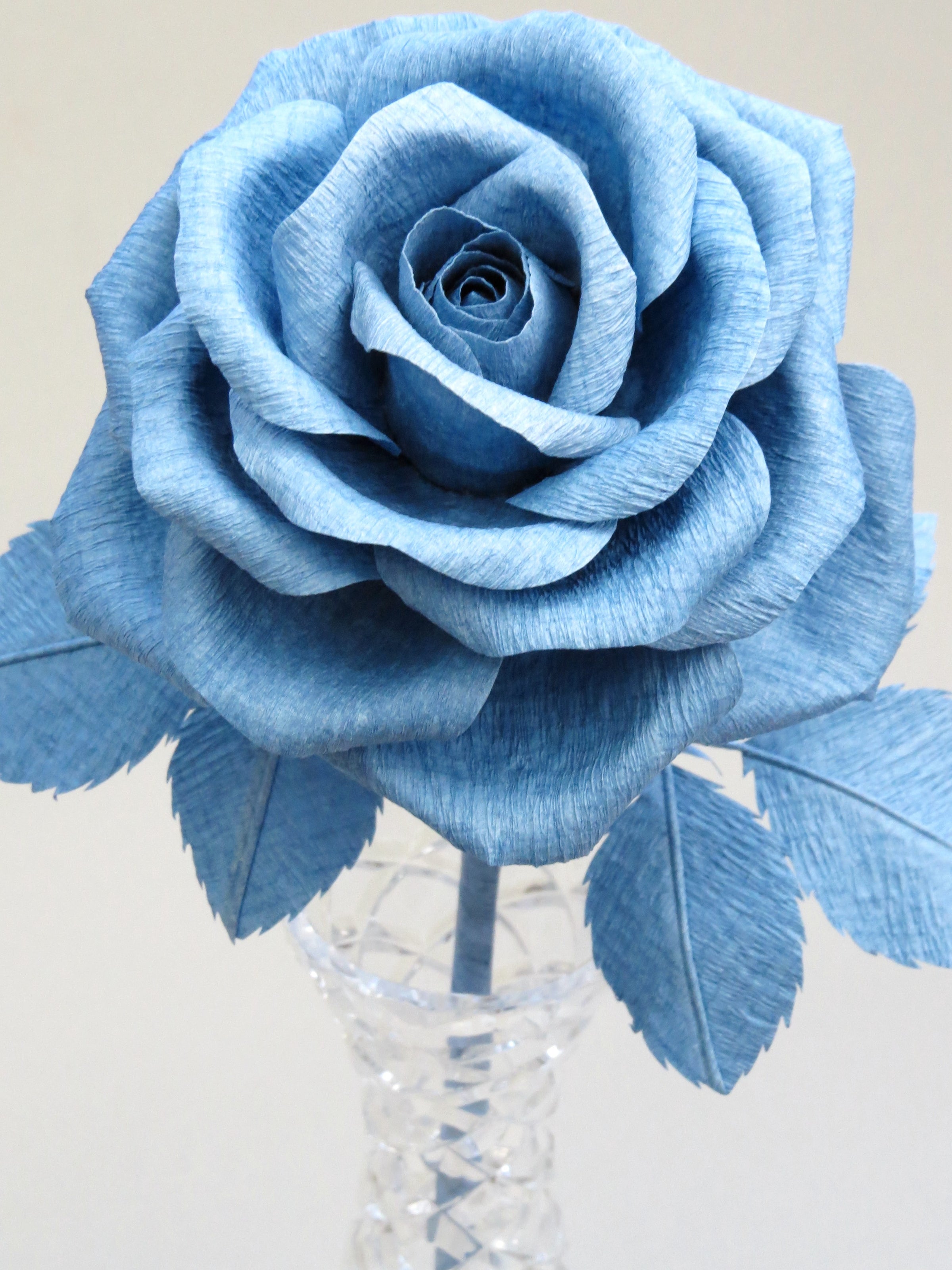 Close up detail of the texture on the petals of a china blue crepe paper rose