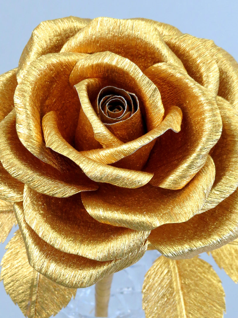 Close up detail of the texture on the petals of a metallic gold crepe paper rose