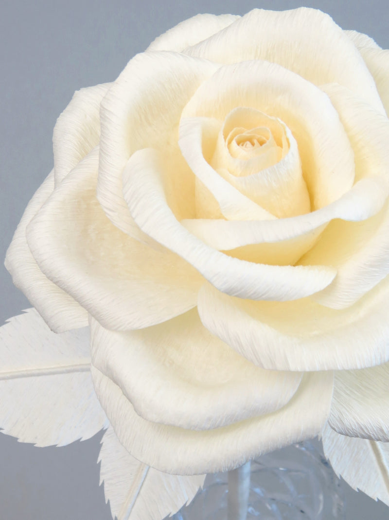 Close up detail of the texture on the petals of an ivory crepe paper rose