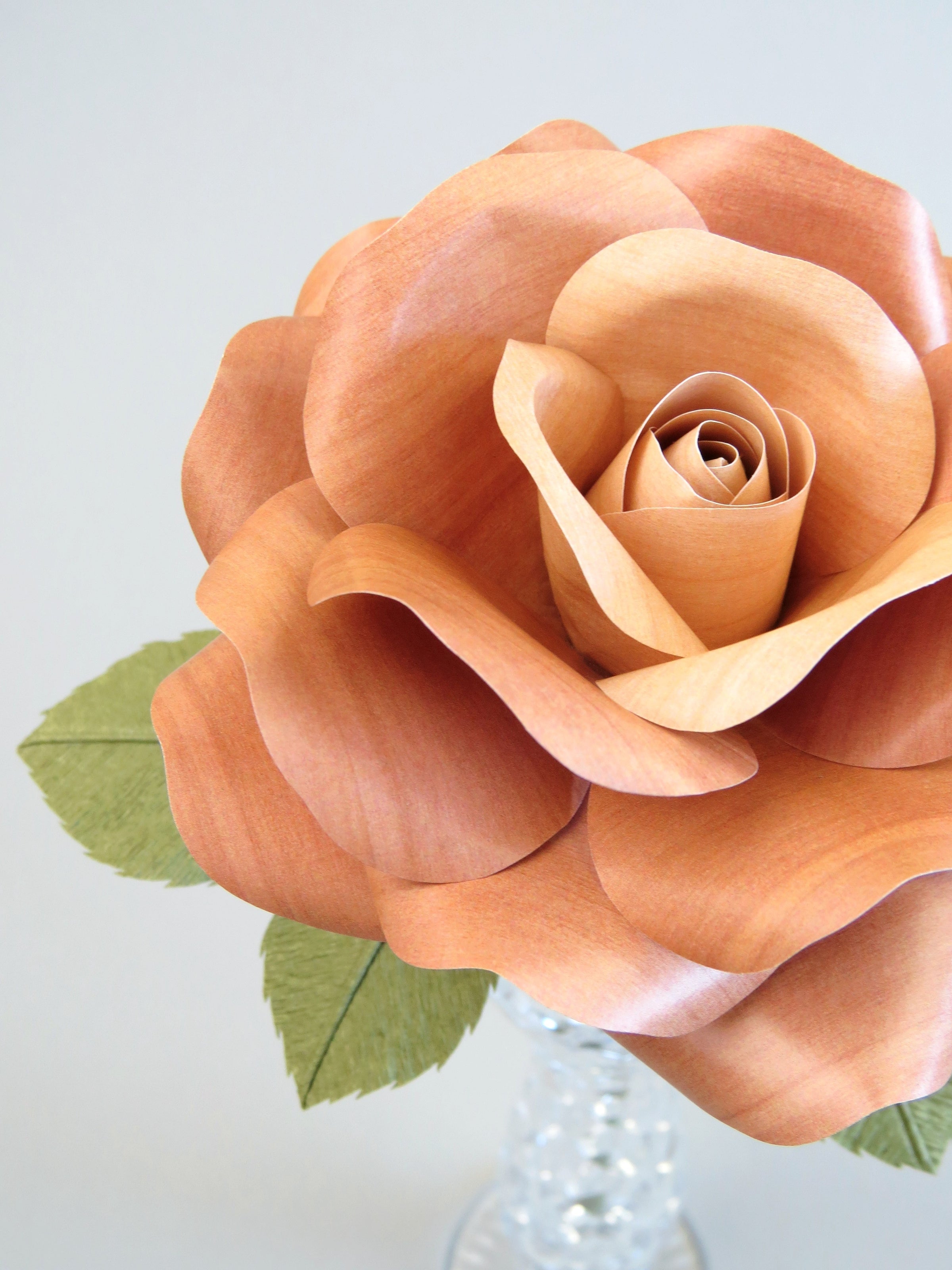 Close up detail of the texture on the petals of a smooth light brown willow printed paper rose