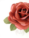 Close up detail of the texture on the petals of a brown leather grain paper rose