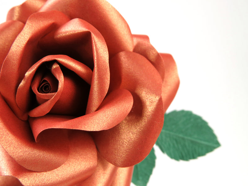 Close up detail of the shimmery texture on the petals of a copper paper rose
