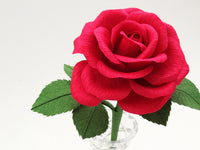 Close up detail of the texture on the petals of a red paper rose